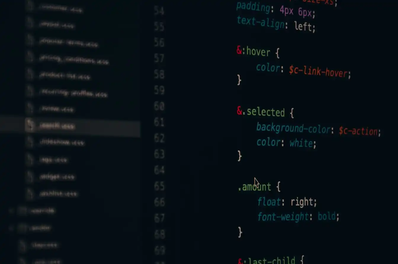Close-up of indented lines of program source code on a dark computer screen.
